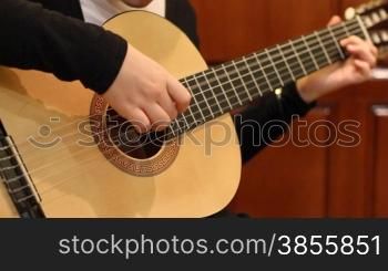 girl studies to play a guitar.