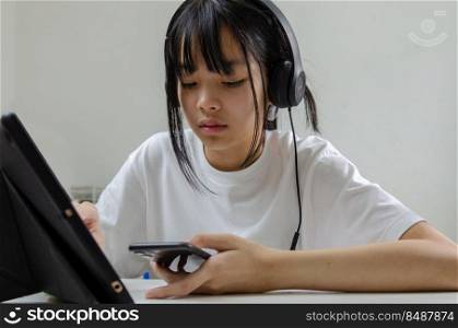 girl study learning digital internet video online computer laptop at home.. girl holding pen writing book study learning digital internet video online computer laptop at home.