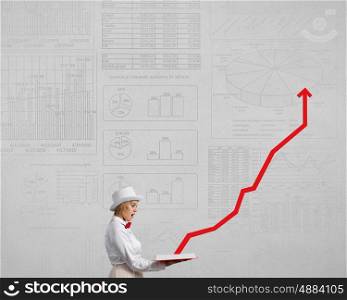 Girl studying finances subject. Young woman in white hat with opened red book in hands
