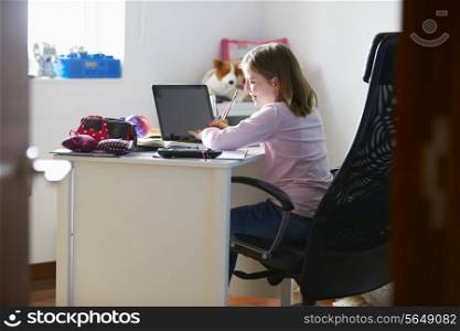 Girl Studying In Bedroom Using Laptop
