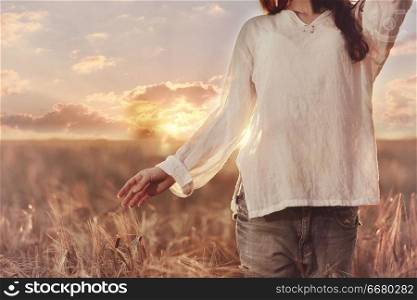 girl sunset in the rustic landscape of wheat