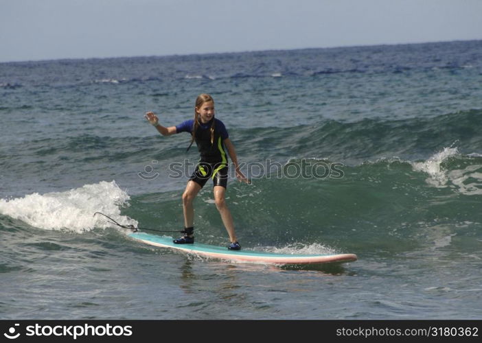 Girl surfing in Maui