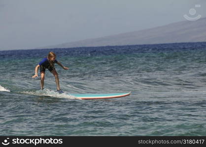 Girl surfing in Maui