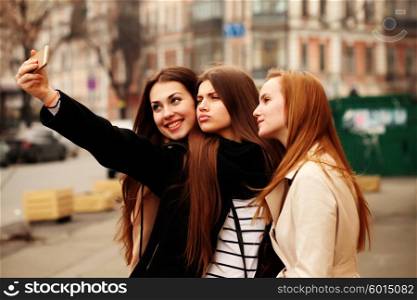 Girl taking a selfie with friends