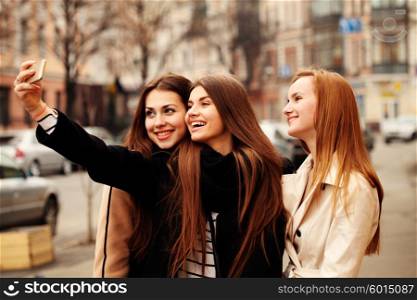 Girl taking a selfie with friends