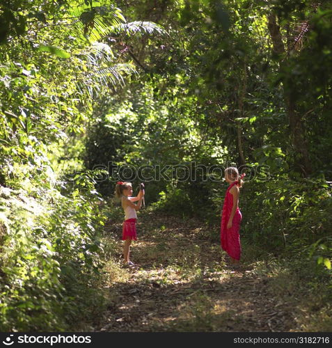 Girl taking pictures in the forest