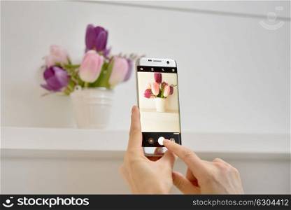 Girl taking pictures of spring flowers