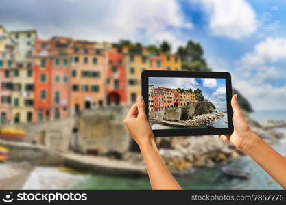 Girl taking pictures on a tablet in Riomaggiore, Cinque Terre, Italy