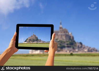 Girl taking pictures on a tablet, Le Mont Saint Michel Abbey, Normandy / Brittany, France