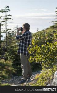 Girl taking pictures on Long Point Hiking Trail, Crow Head, North Twillingate Island, Newfoundland And Labrador, Canada