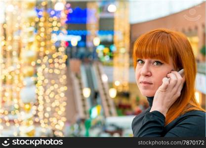 girl talking on the phone in a shopping center