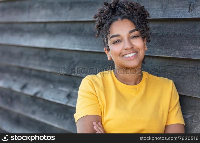 Girl teenager teen female young African American mixed race biracial woman outside smiling with perfect teeth