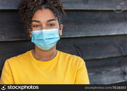 Girl teenager teen mixed race biracial African American female young woman wearing face mask in Coronavirus COVID-19 pandemic