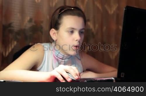 girl-teenager works behind laptop. HD dolly.