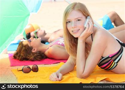 Girl telephoning from the beach