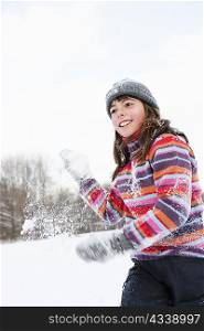 Girl throwing a hand full of snow