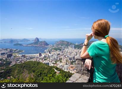 girl tourist looks at Rio landscape and the Pao do Asucar