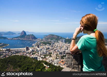 girl tourist looks at Rio landscape and the Pao do Asucar