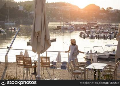 girl tourist stands on the embankment of the sea in the bay of paleokastritsa. Corfu Island in Greece 