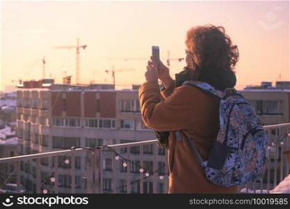 girl tourist taking a photo on a smartphone Saint Petersburg 