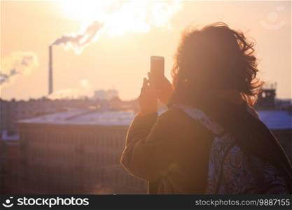 girl tourist taking a photo on a smartphone Saint Petersburg 
