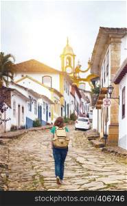 Girl tourist walks in the streets of the famous historical town Tiradentes, Minas Gerais, Brazil