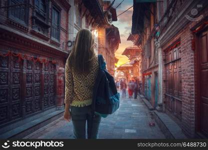 girl tourist with a backpack walking through the city of Kathmandu.. city of Kathmandu.