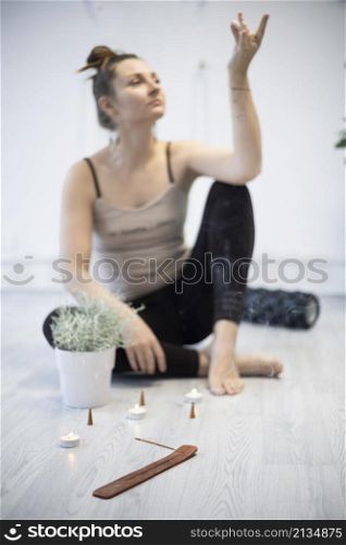 girl training in yoga studio. Healthy and fly Yoga Concept. studio atmosphere - happy smiling girl and incense sticks with candles in the foreground