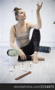 girl training in yoga studio. Healthy and fly Yoga Concept. studio atmosphere - happy smiling girl and incense sticks with candles in the foreground