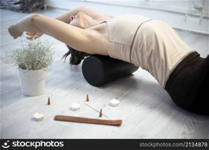 girl training in yoga studio. Healthy and Yoga Concept. girl is engaged on a yoga roller
