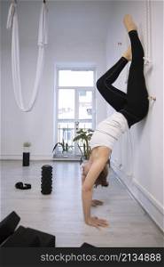 girl training in yoga studio. Healthy and Yoga Concept. girl doing handstand