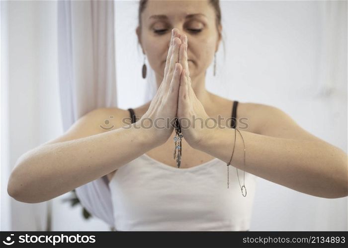 girl training in yoga studio. Healthy and Yoga Concept. hands namaste close-up