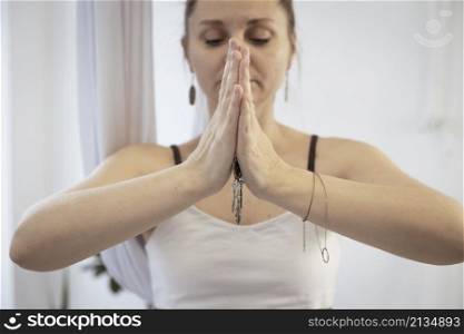 girl training in yoga studio. Healthy and Yoga Concept. hands namaste close-up