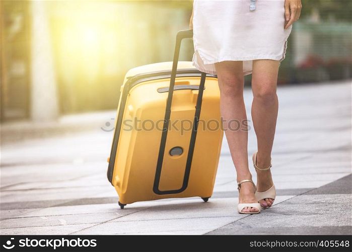girl traveler and her yellow luggage. wonderful travel