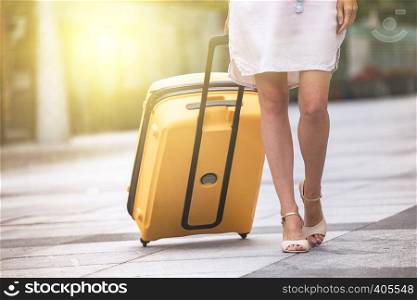 girl traveler and her yellow luggage. wonderful travel