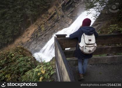 girl traveler looking at the waterfall