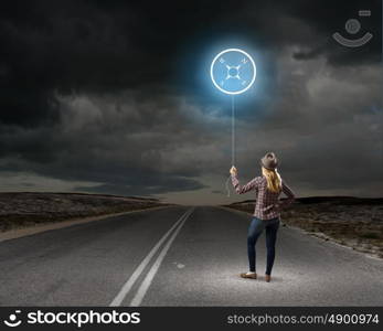 Girl traveler. Young woman holding balloon with compass concept