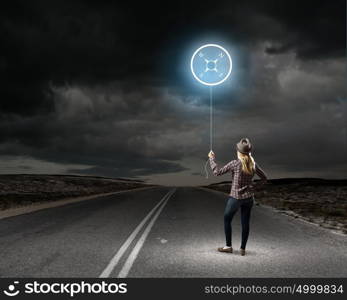 Girl traveler. Young woman holding balloon with compass concept