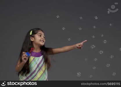 Girl trying to touch a bubble