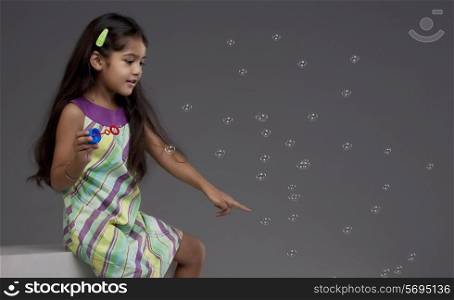 Girl trying to touch a bubble