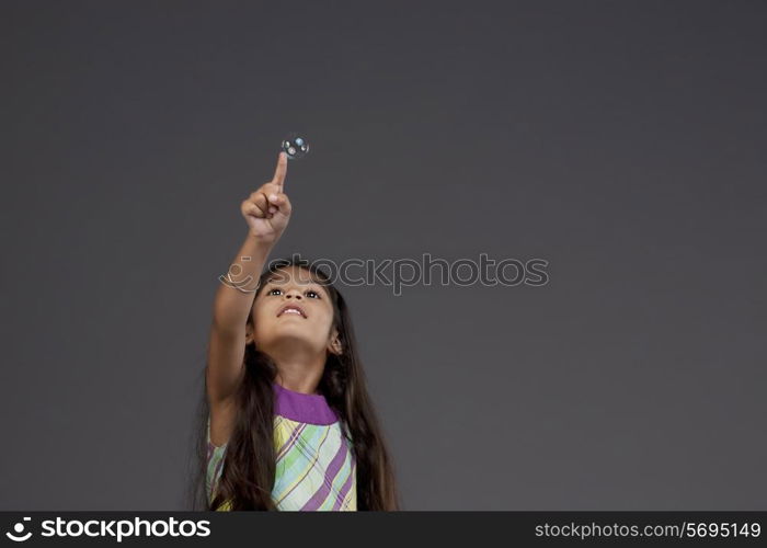 Girl trying to touch a bubble