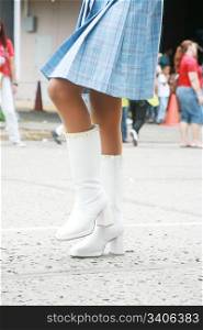 girl using a beautiful boots on a parade