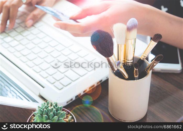 Girl using credit card and laptop computer for online shopping, Beauty and Online shopping concept