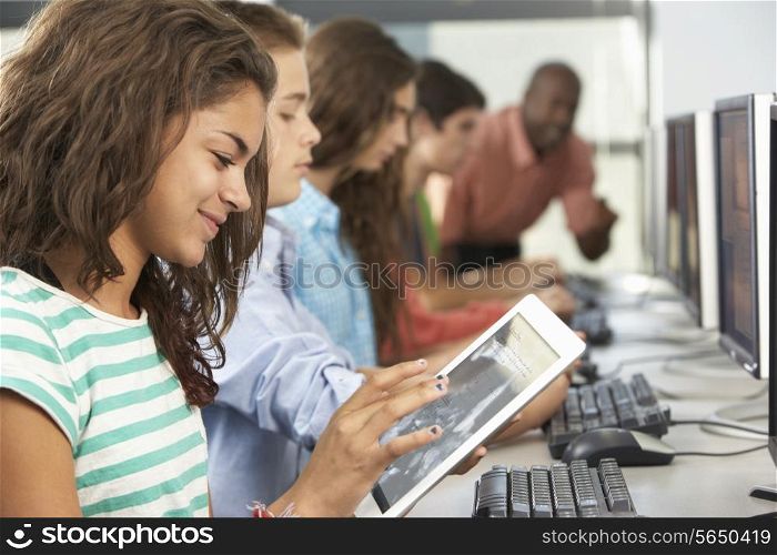 Girl Using Digital Tablet In Computer Class