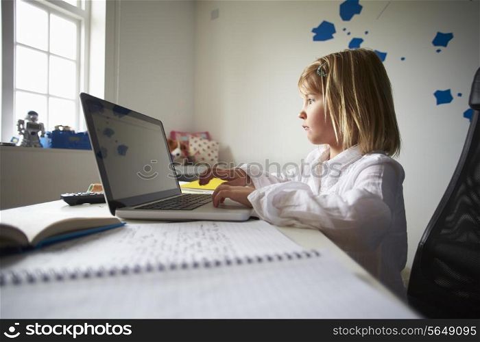 Girl Using Laptop In Bedroom