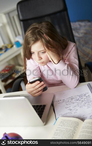 Girl Using Mobile Phone Instead Of Studying In Bedroom