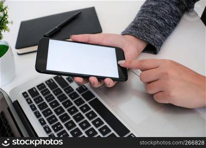 girl using smart phone in office. hand holding smart phone white screen.
