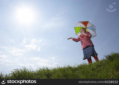 Girl using umbrella on sunny day