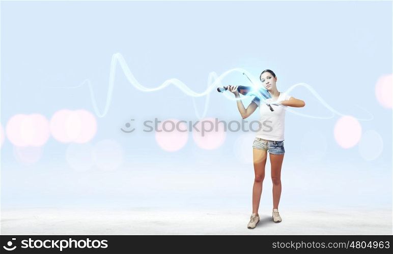 Girl violinist. Young girl in shorts and shirt playing violin