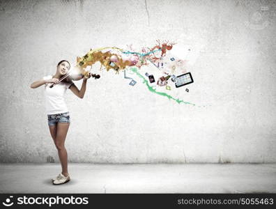 Girl violinist. Young girl in shorts and shirt playing violin